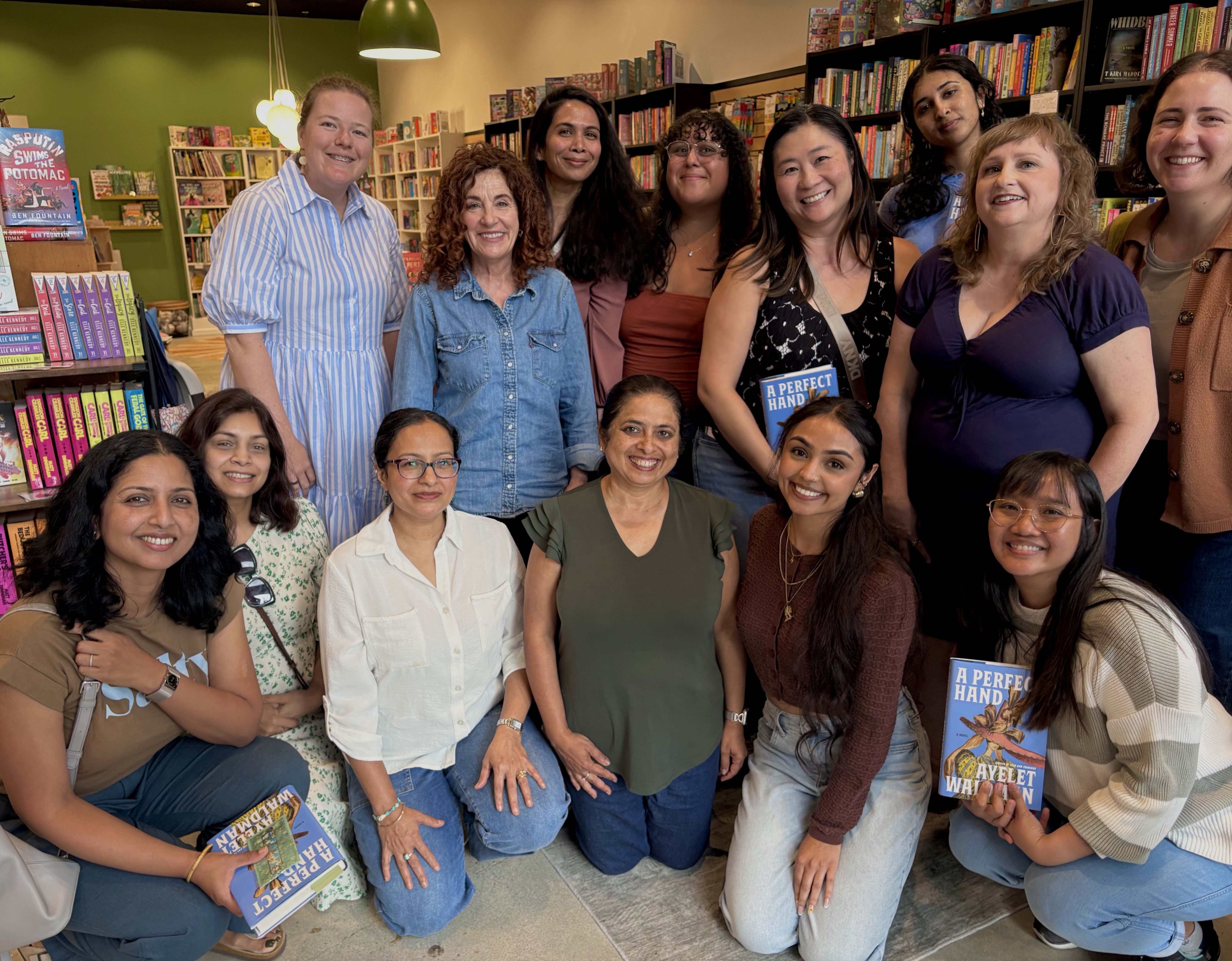 Tri-Valley Readers members posing together with copies of A Perfect Hand at the author meetup with Ayelet Waldman